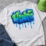White T-shirt mockup with Henri green-and-blue drip graffiti artwork, styled with blue jeans and a lime green hat; accessories not included.