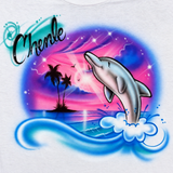 Brightened Chevelle dolphin and tropical sunset artwork close-up on a white shirt.