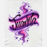 Original Juanita airbrush artwork on a white T-shirt, with flowing black script, pink and purple swirls, dots and white star highlights.