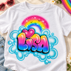 Styled digital mockup of a white Lisa rainbow bubble-letter name shirt with a pink heart and turquoise clouds, paired with denim, pink sunglasses and rainbow accents.