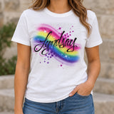 Worn-shirt mockup featuring the original Lyndsay black-script airbrush artwork, rainbow shading, purple bubbles and white star highlights on a white T-shirt.