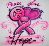 Pink peace sign, heart and awareness ribbon with Peace Love Hope script, flowing swirls and star accents on a white airbrushed shirt.