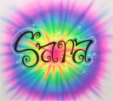 Original hand-airbrushed Sara name in black script with a white outline over a rainbow tie-dye-style burst in pink, purple, blue, green and yellow.