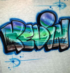 Kevin in rounded graffiti letters filled with blue-green beach scenery, bird silhouettes, shoreline grasses and a fence, framed by blue starbursts.